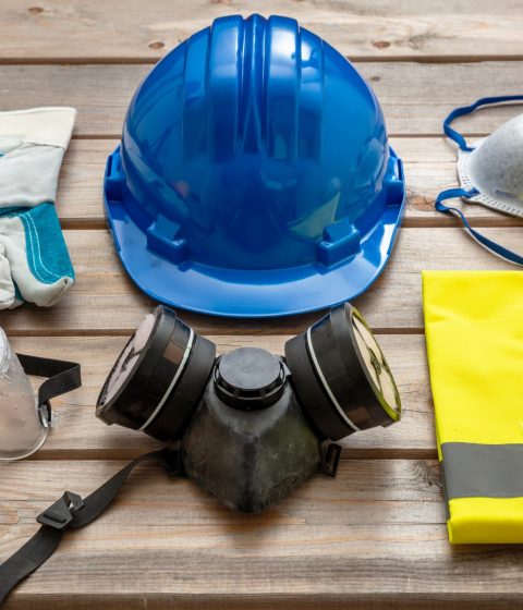 work-safety-protection-equipment-on-wooden-backgro-EVCJ6PS-min